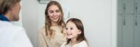 Little girl visiting doctor in medical office